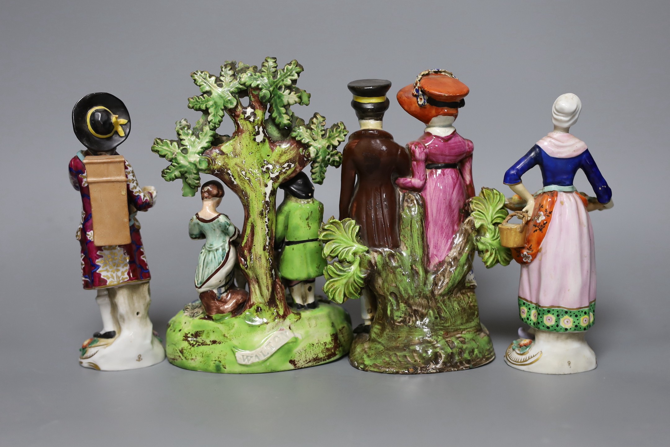 A Walton pearlware group ‘Tenderness’, a Walton type pearlware group of a couple, c.1820, and two Continental porcelain figures, tallest 18.5cm